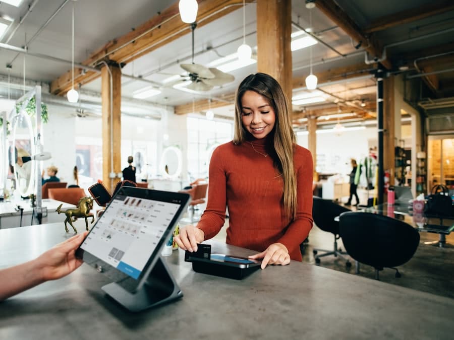 A shopkeeper taking a card payment at a well-kept counter.